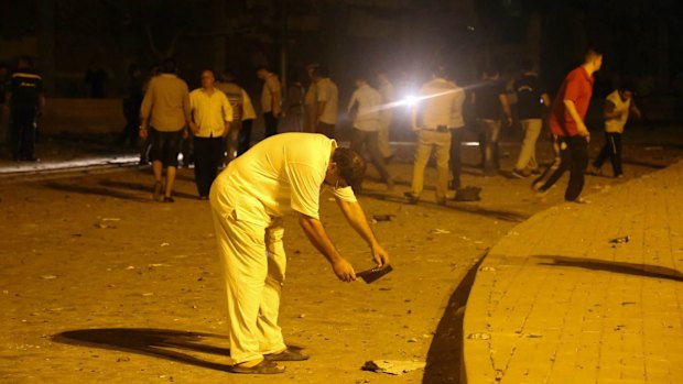 A man takes pictures after the bomb exploded.