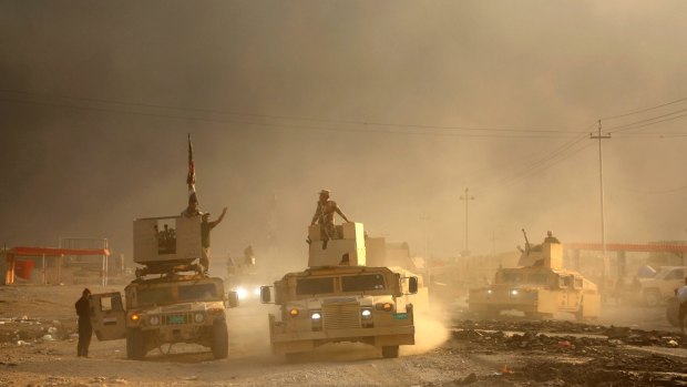 An Iraqi military convoy advances towards the city of Mosul, on Wednesday.