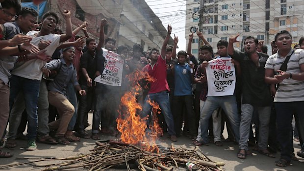 Bangladeshi students protest in April, demanding the arrest of three motorcycle-riding assailants who hacked student activist Nazimuddin Samad to death in Dhaka. 