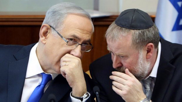 Israeli Prime Minister Benjamin Netanyahu, left, speaks with his then cabinet secretary Avichai Mandelblit in December 2015. 