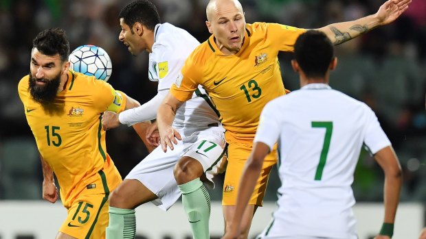Aaron Mooy and Mile Jedinak in the midst of the action. 
