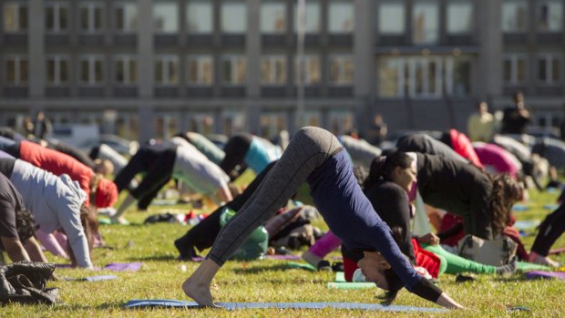 Canberrans participate in an outdoor yoga class to mark the official International Day of Yoga.