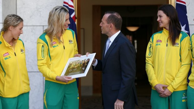 Mr Abbott poses for photos with the Australian Diamonds in the Prime Minister's courtyard.
