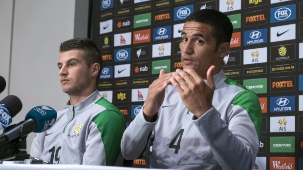 Terry Antonis and Tim Cahill before training on Monday.