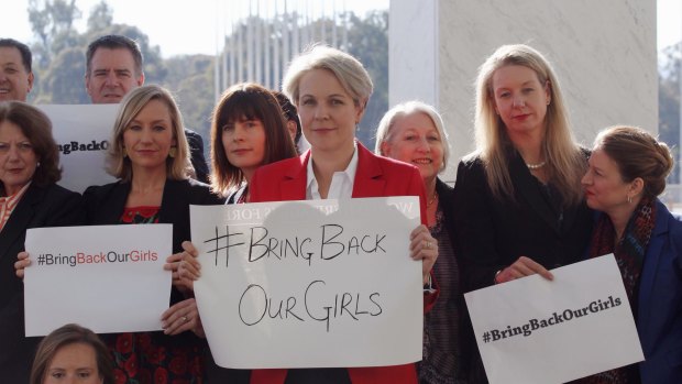 Concerned MPs, including Shadow foreign minister Tanya Plibersek, display #bringbackourgirls signs outside Parliament House in Canberra in 2014.