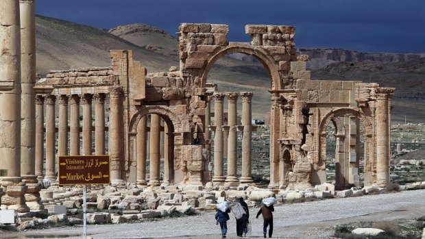 Syrians walking in Palmyra, 215 kilometres north-east of Damascus.  