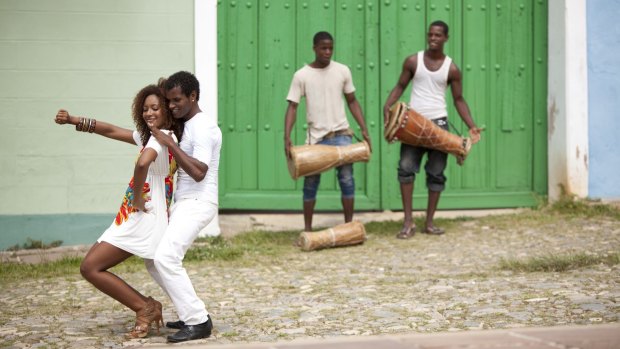 Young black couple dancing salsa in Trinidad, Cuba.