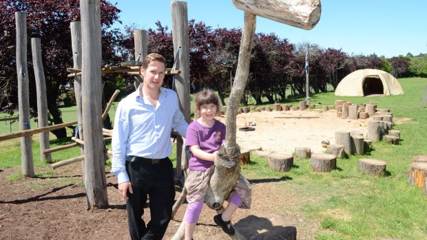 Thriving: Molly, 6, with principal Joel Hines, has taken to the nurturing environment of Daylesford's Dharma School. 