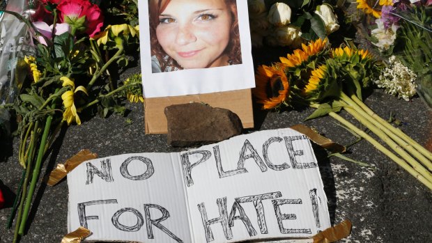 A makeshift memorial of flowers and a photo of victim Heather Heyer sits in Charlottesville, Virgnia on Sunday.