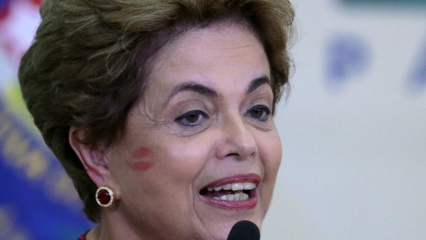 Brazilian President Dilma Rousseff sports a kiss from a supporter on Monday.  