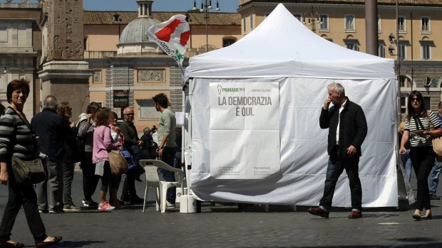 Citizens line up at a makeshift polling booth for Italy's Democratic party's primary elections, in Rome on Sunday.