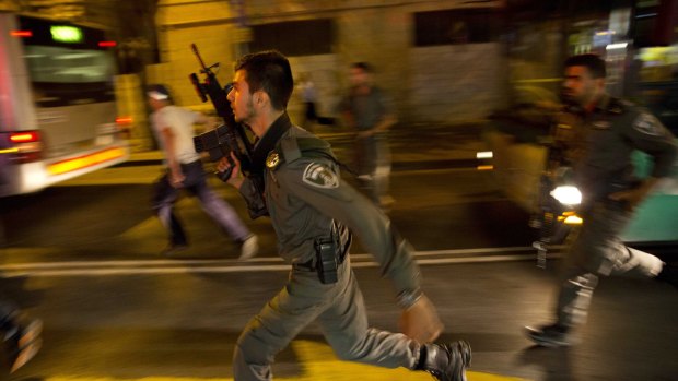 Israeli policemen run looking for a possible stabbing suspect in Jerusalem on Wednesday.