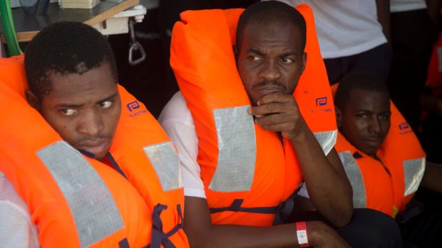 Migrants who were rescued the previous day wait for their transfer to another ship that will take them to Europe, in the Mediterranean Sea, off the Libyan coast, on Monday.