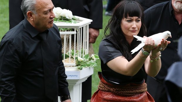 Jonah Lomu's widow, Nadene, releases a dove as his casket leaves the field at the public memorial at Eden Park on November 30.