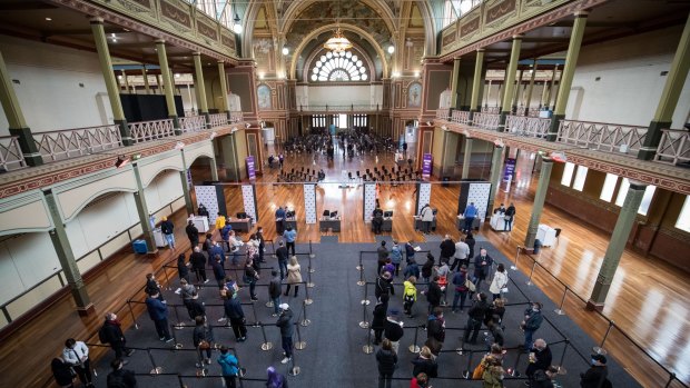 People queue to get their vaccinations in the Royal Exhibition Building.