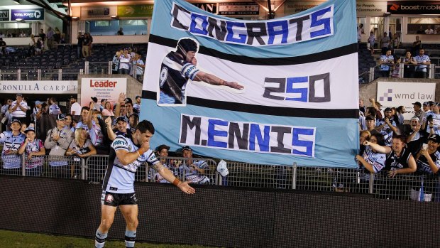 Sharks fans love their No.9: Michael Ennis celebrates with fans in front of a banner made to celebrate his 250th NRL game in March.
