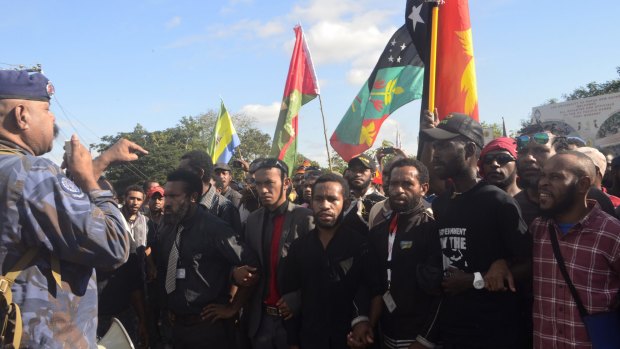PNG PM Peter O'Neill (not pictured) said protesters threw rocks at police.