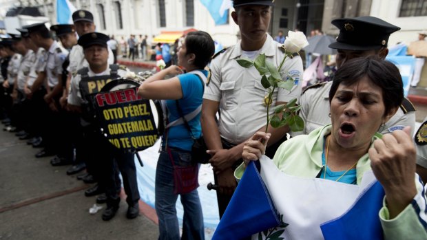 A demonstrator shouts slogans against Guatemalan President Otto Perez Molina outside the Congress building during a session to remove the president's immunity from prosecution in Guatemala City on Tuesday.