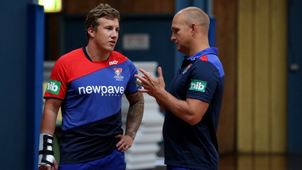 Talking tactics: Knights coach Nathan Brown chats with Trent Hodkinson.
