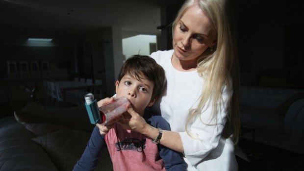 Air flow: Michelle Donegan helps her son Zac Shahidi, 4, take his asthma medication. 