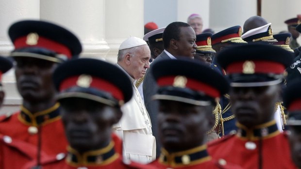 Pope Francis is flanked by Kenya's President Uhuru Kenyatta as they review the honour guard at Nairobi's State House on Wednesday. 