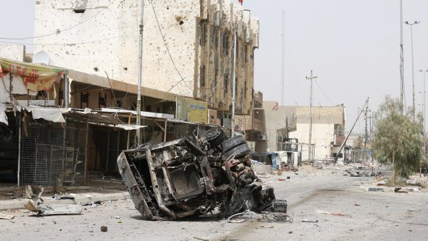 A destroyed vehicle in Fallujah on Tuesday. 