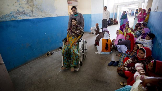A patient is wheeled out of an operation room after sterilisation surgery at a government hospital in Mahendragarh.