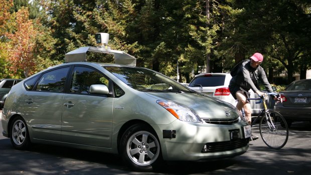 A self-driving car developed and outfitted by Google, with device on roof, at Google headquarters in Mountain View, California.