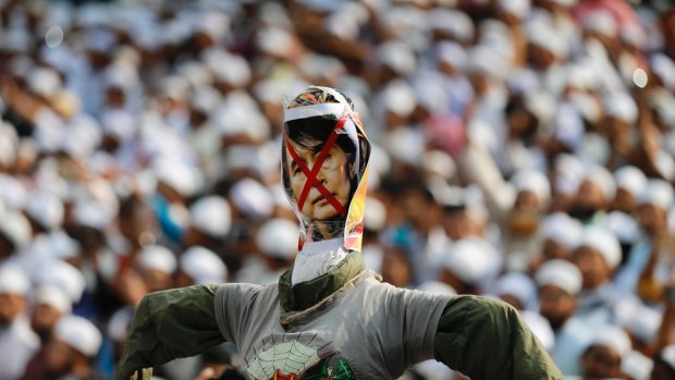 An effigy of Myanmar's Foreign Minister and Nobel Peace laureate Aung San Suu Kyi is held high before being burnt at a protest in Dhaka, Bangladesh, in November.