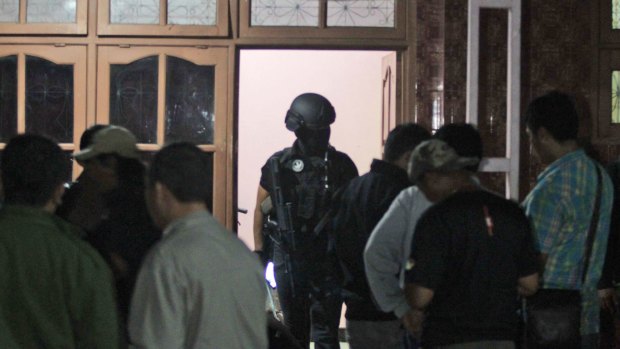 Indonesian police officers from Special Detachment 88 anti-terror unit raid a hideout used by suspected militants' in Mojokerto, East Java.