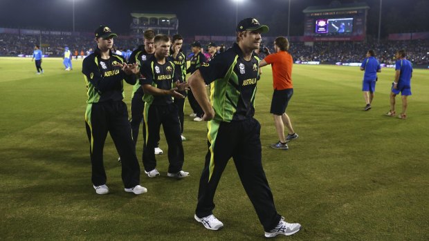 End of an era: Shane Watson leads his team from the ground after his last match of international cricket.
