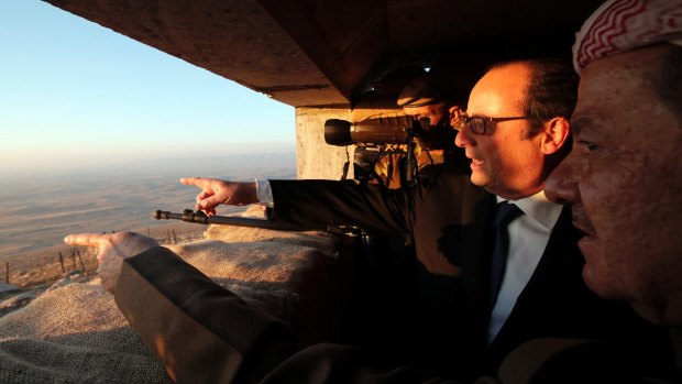 French President Francois Hollande and Massoud Barzani, right, President of the Iraqi self-ruled Kurdish region, point towards IS-held territory on the outskirts of Mosul.
