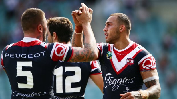 Roosters on the fly: Blake Ferguson celebrates with teammates after scoring against the Canberra Raiders.