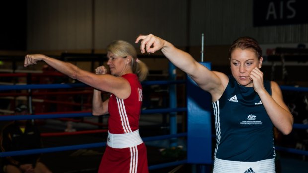Shelley Watts (right) takes AOC chef de mission Kitty Chiller through a sparring session.