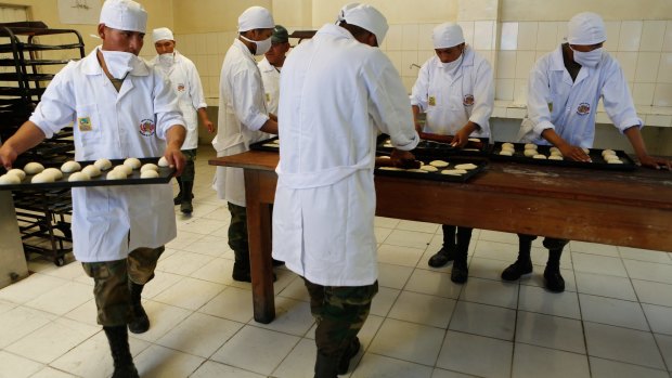 Bolivian soldiers make bread at the Miraflores army barracks in La Paz, Bolivia, on Tuesday.
