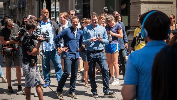 Seth Meyers, centre, host of Late Night with Seth Meyers on NBC, walks down Fifth Avenue in the Flatiron neighborhood in New York during the taping of a segment for his television program. 
