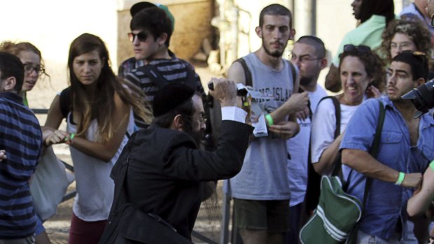 A man identified as Yishai Schlissel charges at spectators with a knife at the Jerusalem Gay Pride Parade.