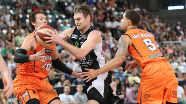 Crowded lane: Melbourne United veteran Mark Worthington tries to evade the Cairns defence.