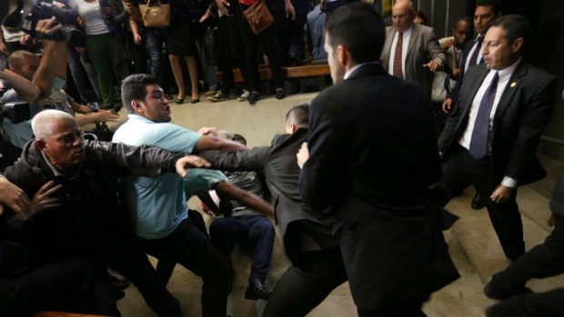 Protesters invade the Brazilian Congress on Wednesday, causing scuffles and forcing the suspension of proceedings.
