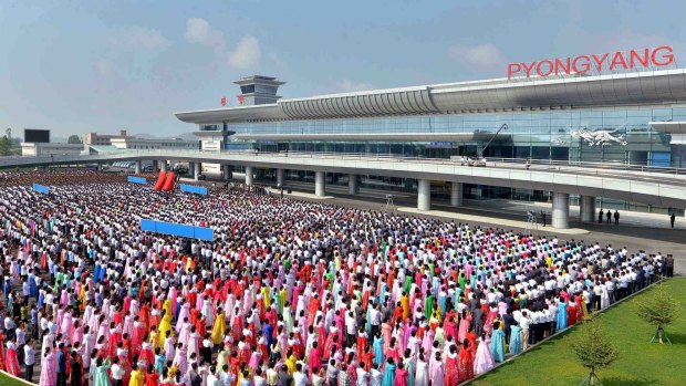 People attend the opening ceremony for the newly built terminal of Pyongyang International Airport in this undated picture released on Wednesday.