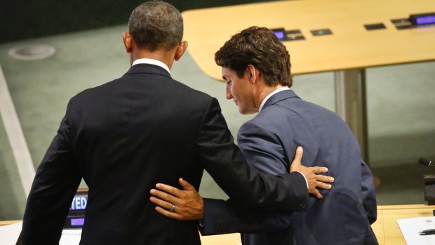 President Barack Obama, left, and Canadian Prime Minister Justin Trudeau embrace after addressing the Leader's Summit on Refugees