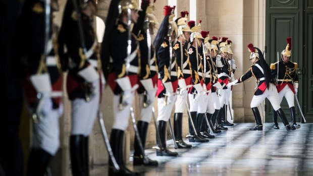 Republican guards take their places prior to the arrival of French President Emmanuel Macron at the Versailles Palace for his joint sessions of Parliament speech on Monday.