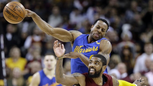 Cleveland Cavaliers' Kyrie Irving (2) and Golden State Warriors' Andre Iguodala (9) battle for a loose ball in last year's NBA finals.
