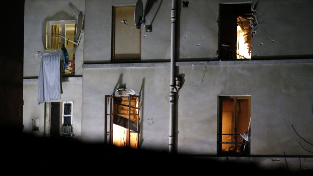 Bullet holes and smashed windows on the back of the building after the raids in Saint-Denis, Paris, on Wednesday.