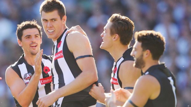 Mason Cox of the Magpies celebrates after his first kick in his first match yielded Collingwood's first goal.