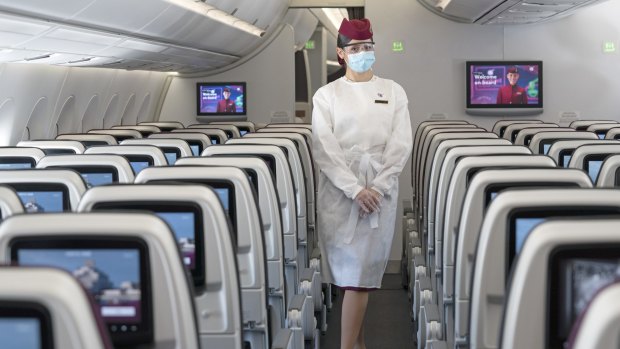 A Qatar Airways flight attendant wearing her personal protective equipment (PPE). 