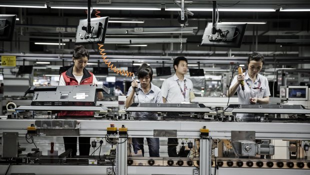 Workers assemble monitors at a TCL factory in Guangdong province, China. 