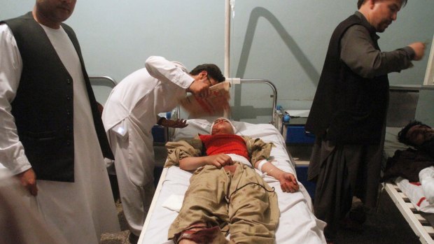 Relatives assist a wounded man in a hospital after a suicide attack on a mosque in Herat, Afghanistan on Tuesday.