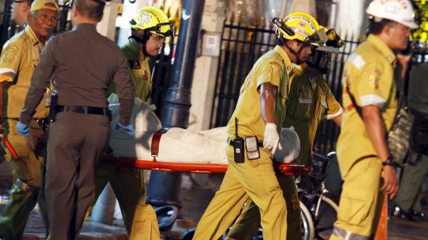 Rescue workers carry the body of a victim from the Erawan shrine.
