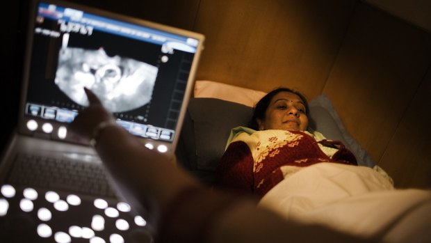 A woman has a scan of her uterus and ovary lining at a fertility hospital in Delhi, India.